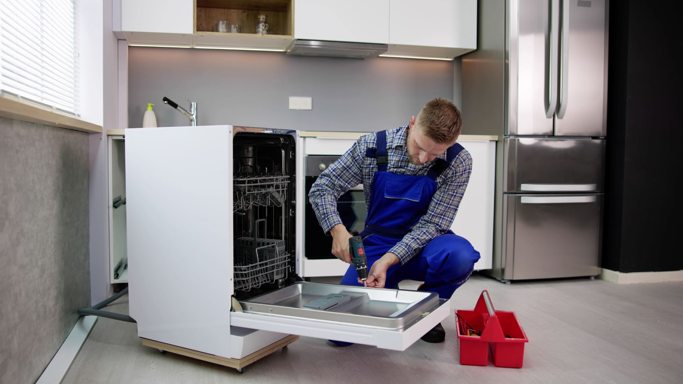 Appliance repair technician fixing a washing machine