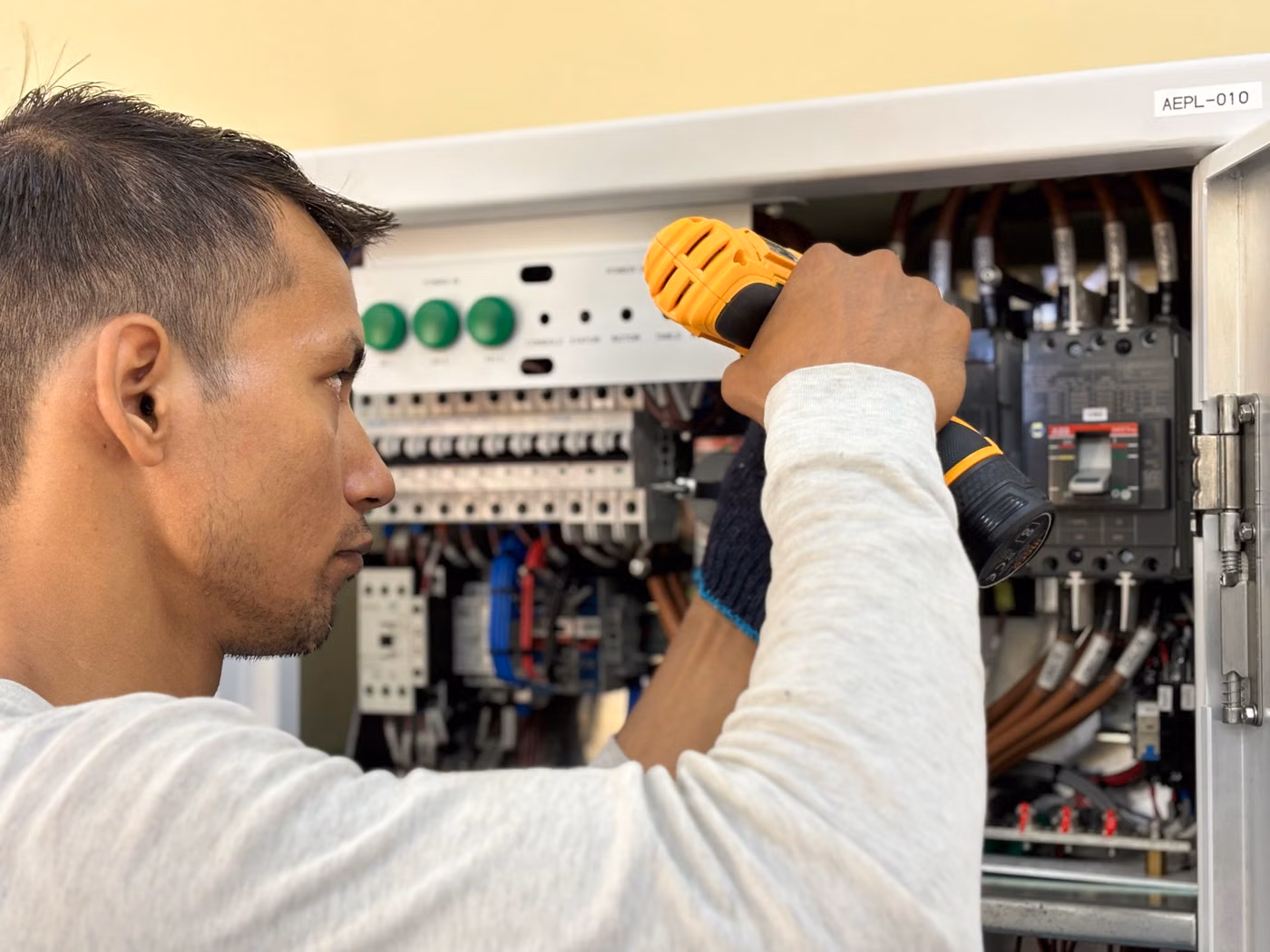 Electrician inspecting a residential circuit breaker panel
