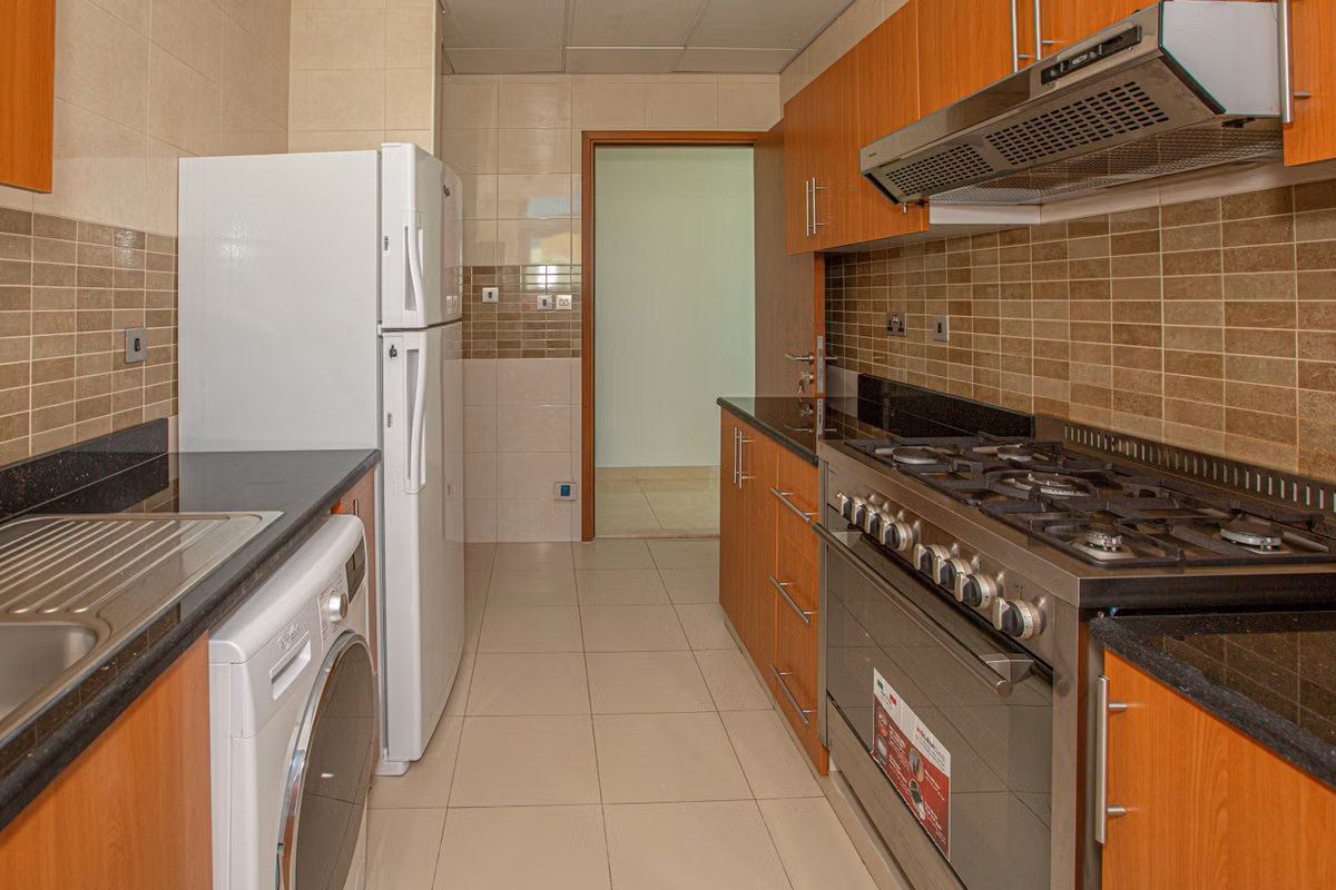 Residential kitchen with refrigerator and other major household appliances